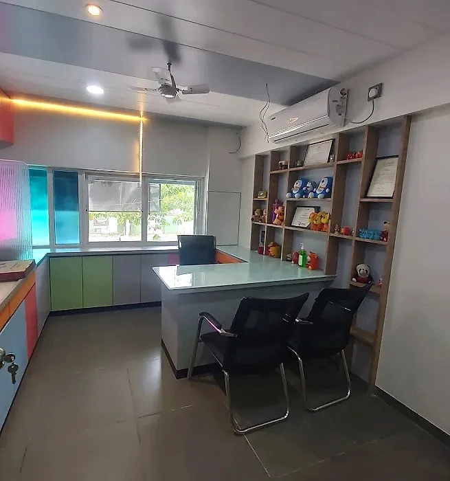 Dr. Mamta's bright consultation room with colourful cabinets and shelves of soft toys